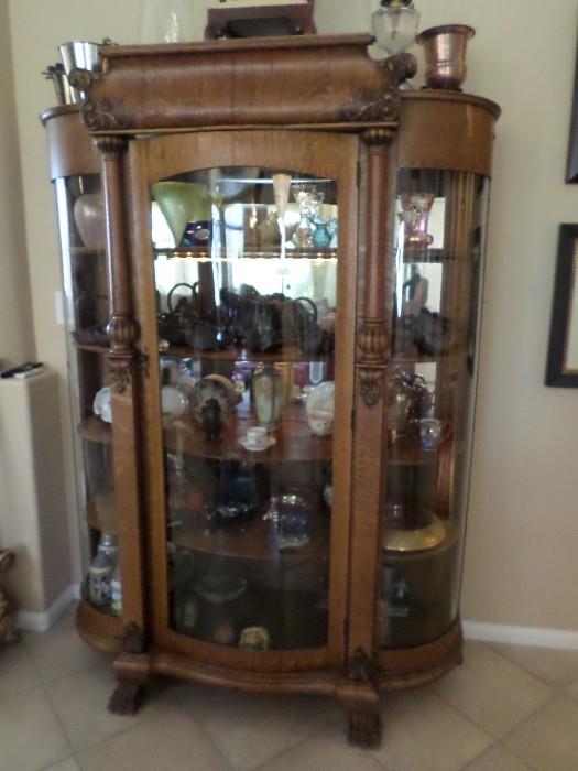 antique  claw foot oak curio cabinet, rounded glass, 3 shelves.  circa 1865