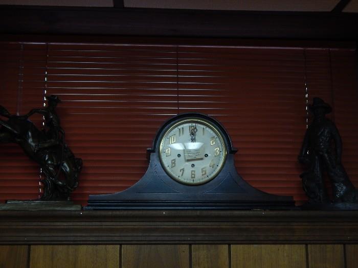 Another mantle clock with bronzes on either side.