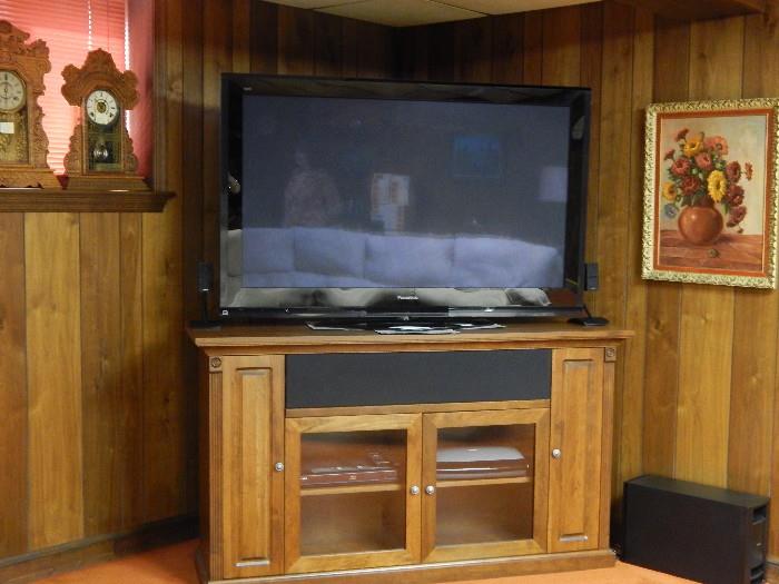 Flat screen television with a nice Baker entertainment console.