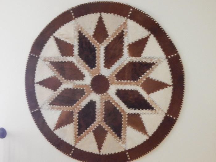 Southwest cowhide art pinwheel for the wall.