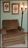 Overstruffed chair, floor lamp and wall art