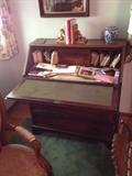 Walnut desk with four lower drawers, drop down writing surface and original hardware.