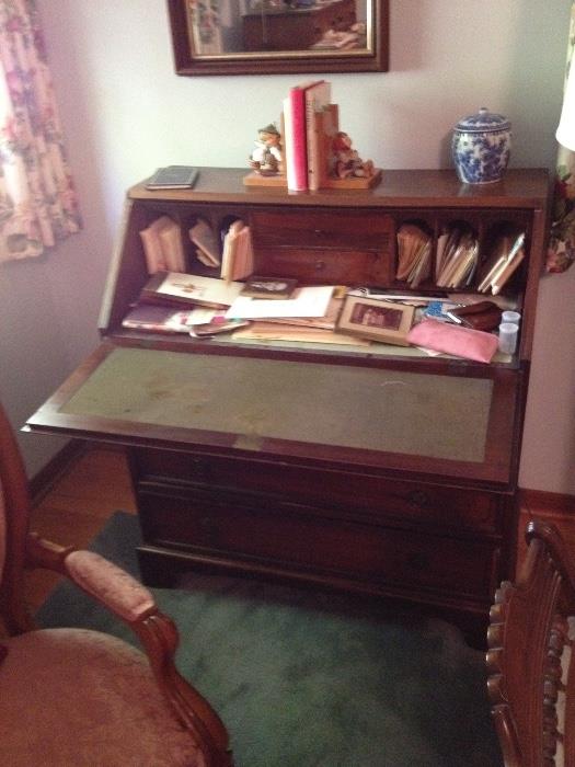Walnut desk with four lower drawers, drop down writing surface and original hardware.