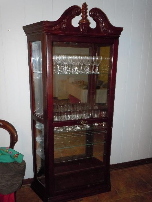 Quality sliding door china cabinet with mirrored back, lighted, and glass shelves