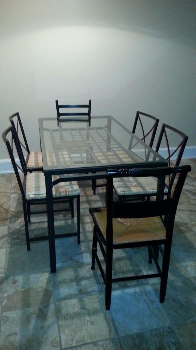 glass and black metal dining room table, chairs for 6