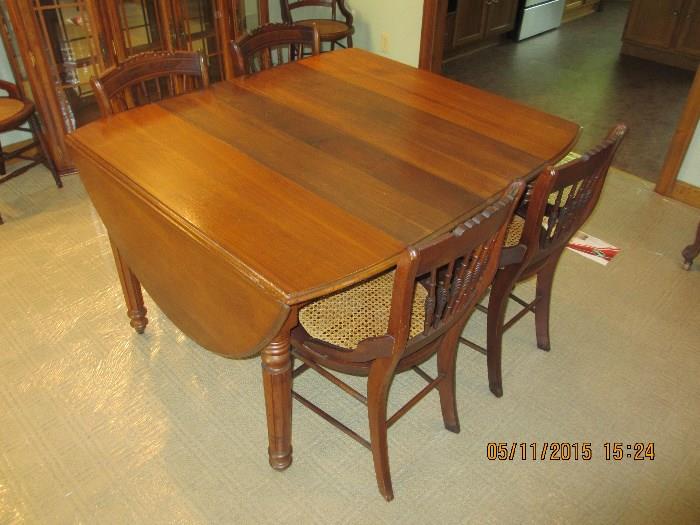 Antique Dining Room Table with 6 caned bottom Chairs  