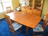 Very nice Danish-mid century modern dining room table and chairs. 2 Leaves are contained within the table and pop into place!