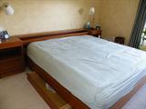 Bed is King size teak wood with storage underneath and within the headboard