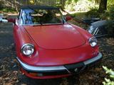 1987 Cherry red Alfa Romeo Spider Veloce with black interior, standard transmission 5 speed. 4 cylinder engine. A beautiful Automobile