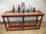 Vintage bottles and antique bottle collection displayed on a very nice sofa table-also for sale.