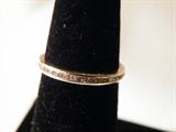 14kt yellow gold eternity band with inset diamonds surrounding the band. Nice jewelry.