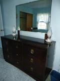 Vintage mahogany bedroom dresser with mirror.