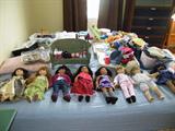 American girl dolls and a bed full of accessories and clothes!
