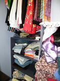 Walk in closet full of ladies clothing and accessories.