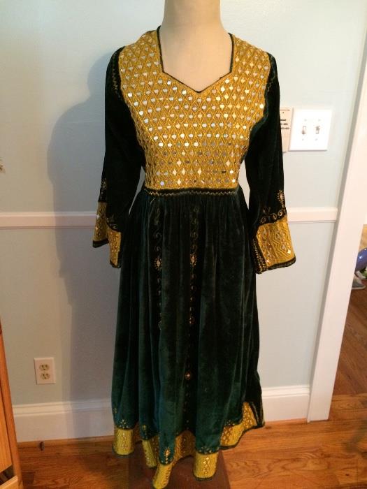 Green velvet dress with real glass mirrors embroidered onto it. This dress originally came from Afghanistan.