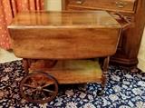 Solid wood, super sturdy, double drop-leaf tea cart by Rockingham.  Opens to a medium size table.  Has one drawer and bottom shelf.