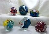 Various paperweights signed by artists:  