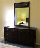 Expresso Brown Dresser with Black faux leather top and mirror accent.