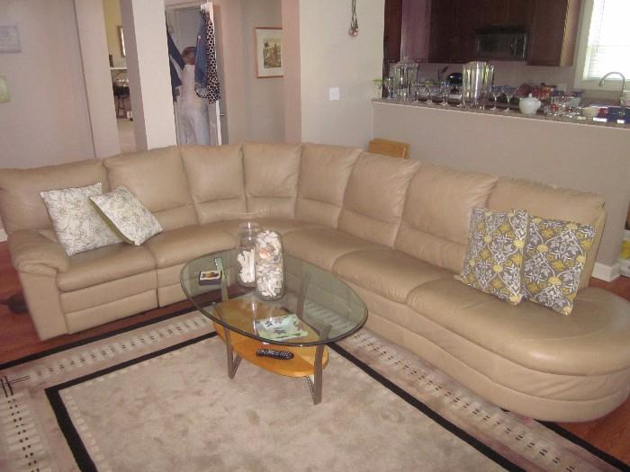 Natuzzi Leather sofa, Recliner at one end. Cocktail table, area rug