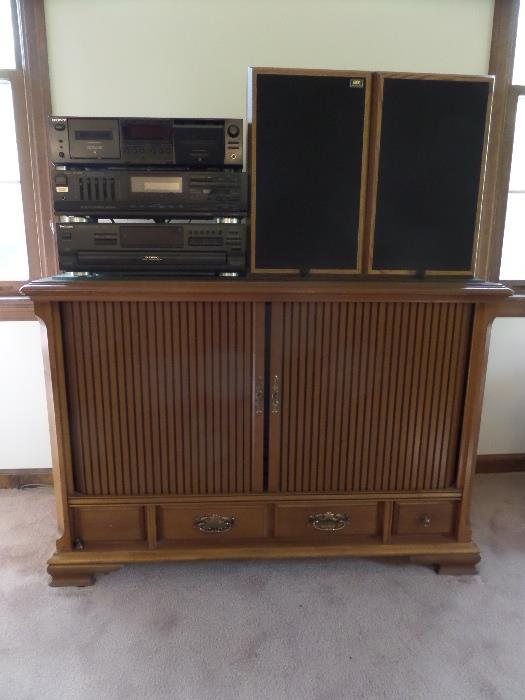 an old console TV cabinet used as a TV stand