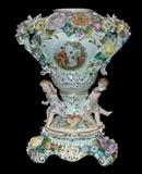 Sitzendorf Potpourri Porcelain Urn, highly detailed. Multiple colors of flowers and vegetation with 2 putti. Circa 1900