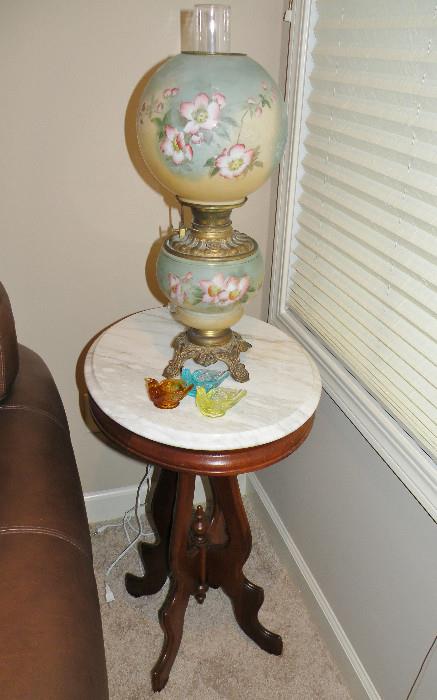 Antique marble top table. Double globe lamp that has been electrified.
