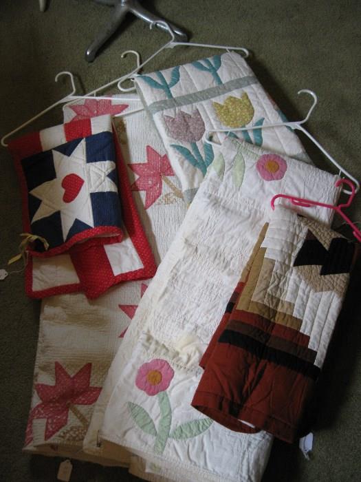 assorted hand made quilts.  Some old, some new.