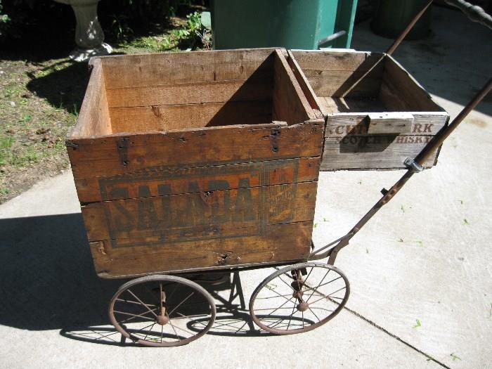 Great Salada Wooden box mounted on old buggy frame with a cuttysark wood box.  Wonderful planter.