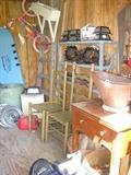 2 ladder back chairs, coal shuttle, small pink bike and shelving and a couple hub caps, and wooden ladder