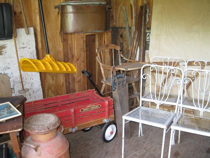 garage is full of treasures; wagon, patio chairs, high chair, milk can, copper pot