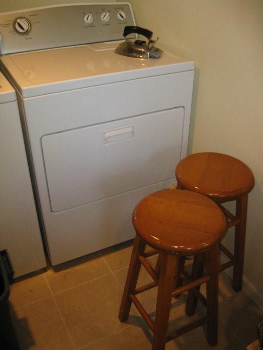dryer and 2 wooden stools