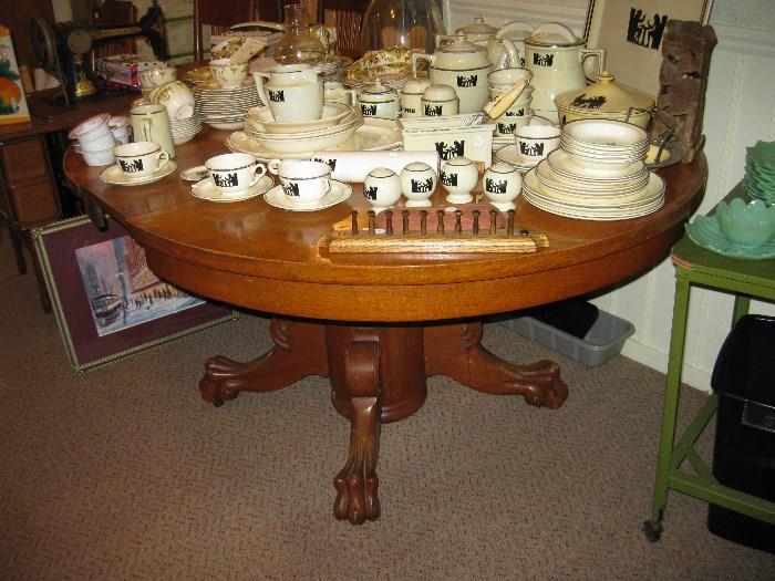 large round oak table with claw feet.