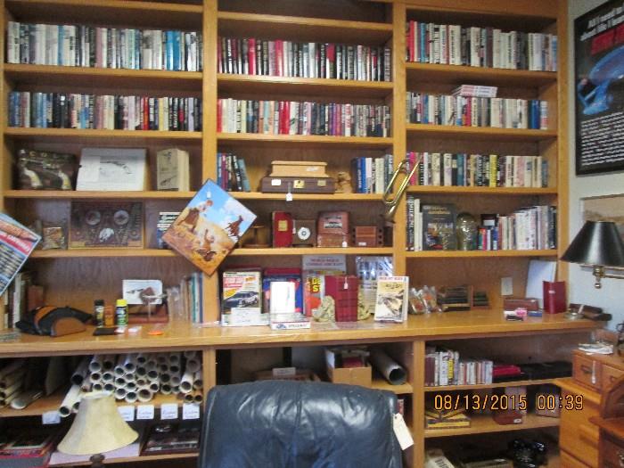 Many books :  Current novels, gun-related books, aviation-related books, rolled-up posters (some vintage), vintage/antique cameras & related books, etc.