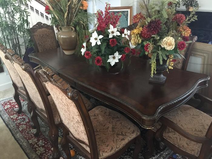 Antique dining wood table with fancy design and arms and base of the table and 8 chairs dark brown
Min bid $400
