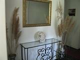 Decorative stand with mirror and vases.
