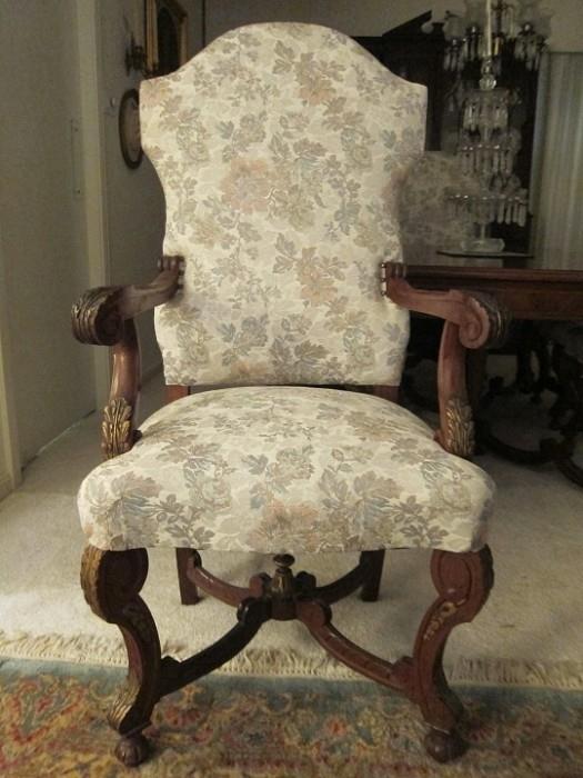 Italian mahogany armchair with parcel gilt carving and stretcher finial.