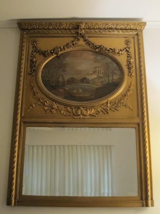 Late 19th century Louis XVI style gilt painted trumeau mirror with oil on canvas depiction of figures in a country setting.