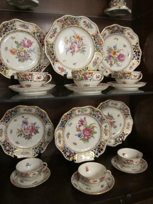 Set of Dresden Carl Thieme hand-painted porcelain dinner ware including 12 plates, 12 cups and 12 saucers. In near mint condition with one plate having minor chip to back. Otherwise no damage or gilt wear.
