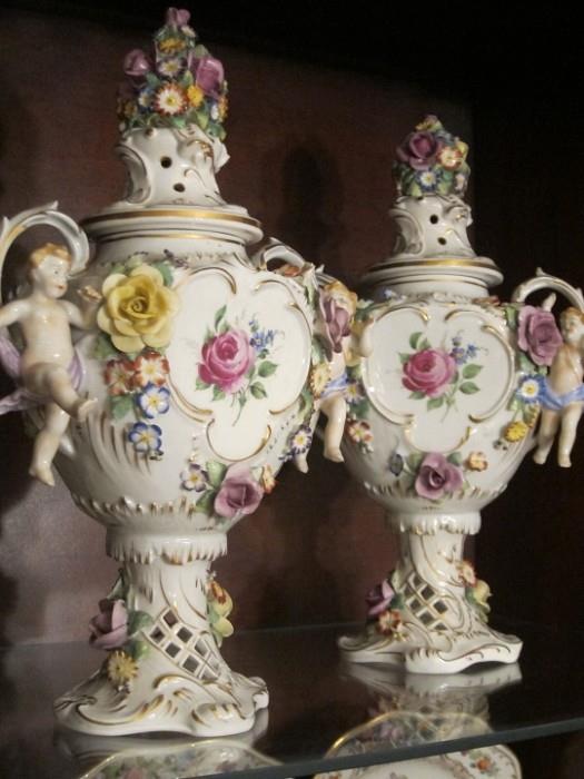 Pair of Von Schierholz hand-painted porcelain urns with cherubs.