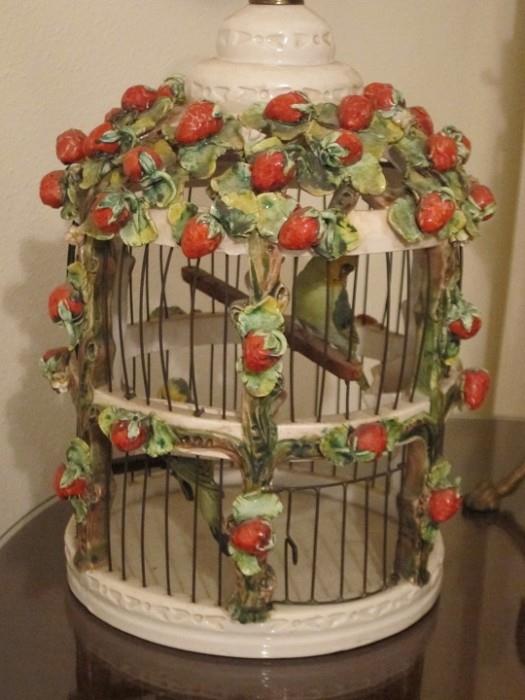Italian hand-painted pottery birdcage with two parakeets.