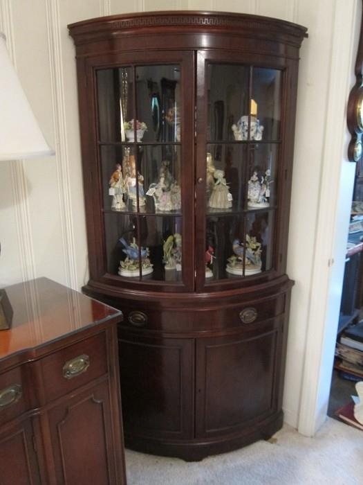 Vintage mahogany lighted corner cabinet.