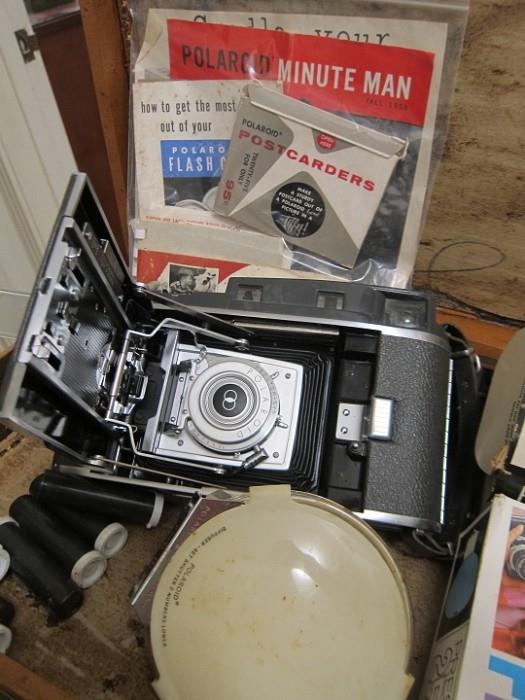 Vintage Polaroid land camera with original flash, flash bulbs and manuals in original case.