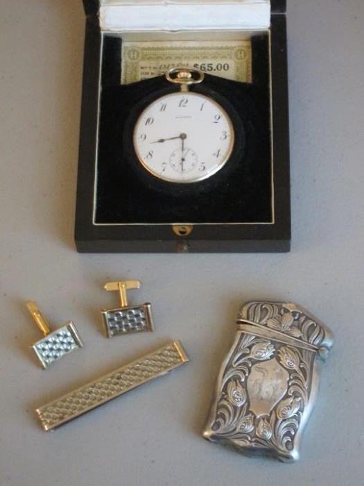 Vintage Howard pocket watch in original case; nice collection of men's cuff links and tie clasps; circa 1890-1910 Art Nouveau sterling silver match safe.