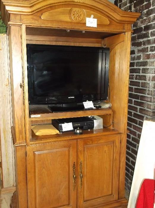 Flat screen TV and oak entertainment cabinet