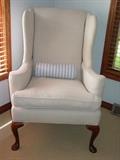 Wing chair upholstered in a linen type fabric.