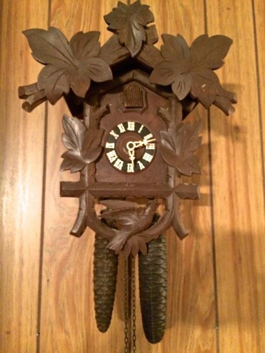 German wood-faced cuckoo clocks, works! Bird pops out and speaks. Weights are cast iron.