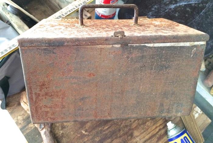 Rusty metal box with brackets for hanging