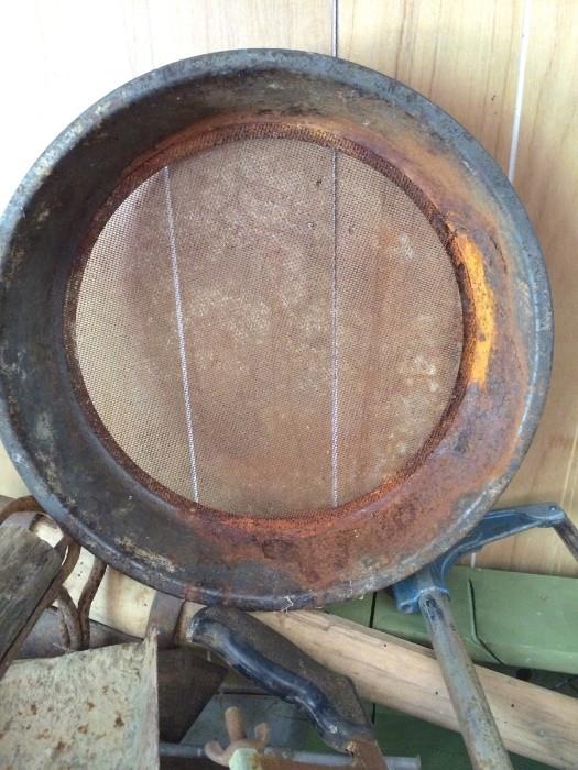 Large rusty metal sieve