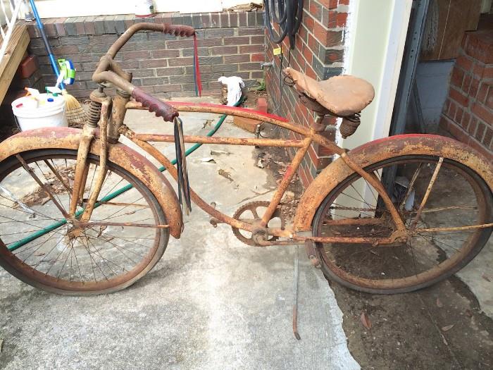 Very vintage bicycle with lots of springy metal detail! Great display piece or for restoration. Note the handle grips!