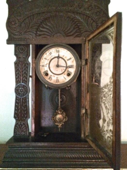 Gorgeous antique mantle clock with etched-glass door and carving to admire